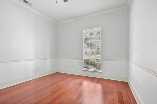 empty room featuring hardwood / wood-style flooring, ceiling fan, and crown molding