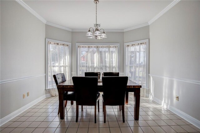 dining space featuring ornamental molding, a chandelier, and light tile patterned flooring