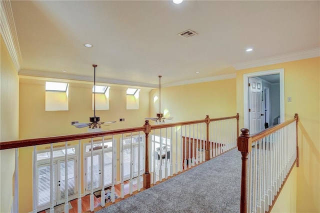 corridor featuring crown molding and carpet