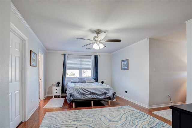 bedroom featuring hardwood / wood-style flooring, ornamental molding, and ceiling fan