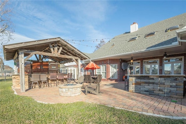 view of patio / terrace with a gazebo, a bar, ceiling fan, and an outdoor fire pit