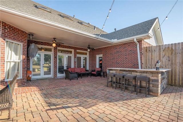 view of patio with french doors, ceiling fan, an outdoor hangout area, and an outdoor bar