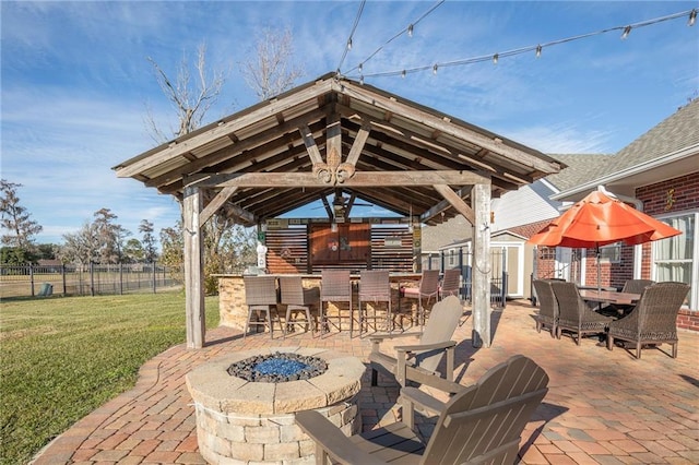 view of patio with a gazebo, an outdoor fire pit, and exterior bar