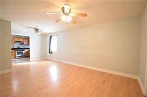 unfurnished room featuring ceiling fan and light hardwood / wood-style flooring