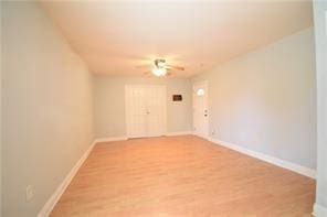 spare room with hardwood / wood-style flooring and ceiling fan