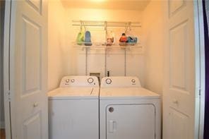 clothes washing area featuring washer and dryer