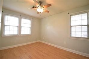 spare room with light hardwood / wood-style floors and ceiling fan