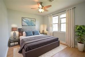 bedroom with ceiling fan and light wood-type flooring