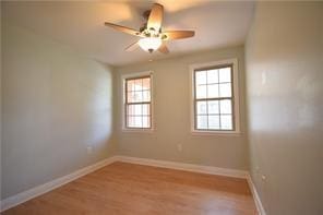 unfurnished room featuring ceiling fan and light hardwood / wood-style floors