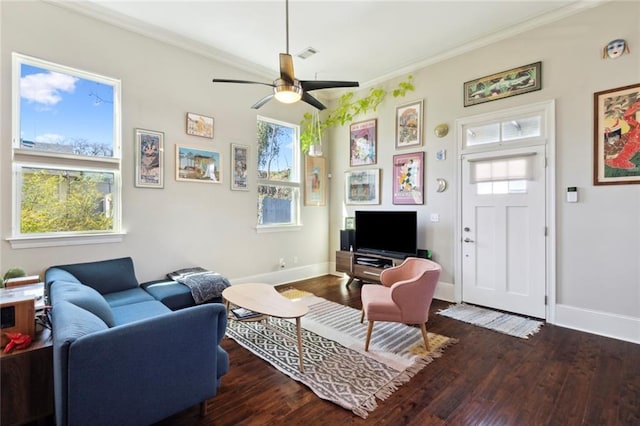 living room with crown molding, ceiling fan, a healthy amount of sunlight, and dark hardwood / wood-style floors