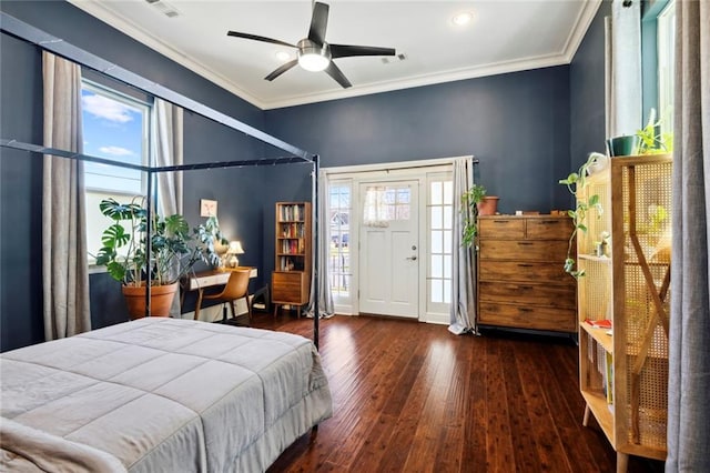 bedroom featuring multiple windows, crown molding, and dark hardwood / wood-style flooring