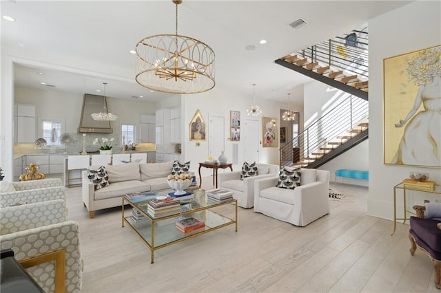 living room featuring light hardwood / wood-style flooring and a notable chandelier