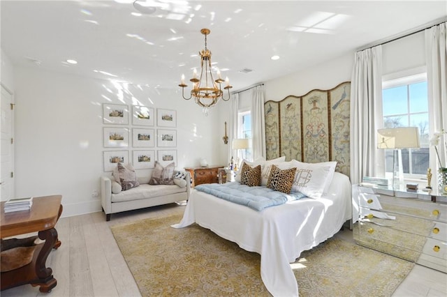 bedroom featuring a notable chandelier and light hardwood / wood-style flooring