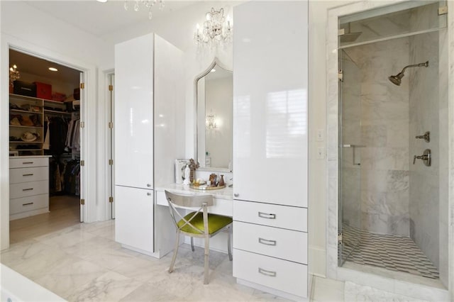 bathroom with walk in shower and an inviting chandelier