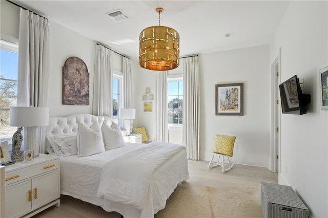 bedroom featuring an inviting chandelier