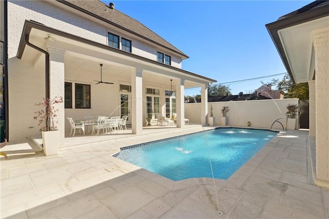 view of pool featuring pool water feature, ceiling fan, and a patio area