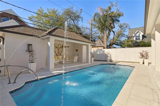 view of pool featuring an outbuilding, a patio area, and pool water feature