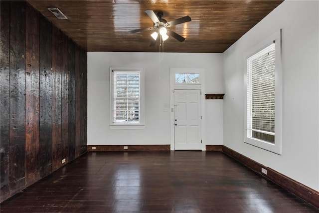 foyer featuring ceiling fan, dark hardwood / wood-style floors, wood ceiling, and wood walls