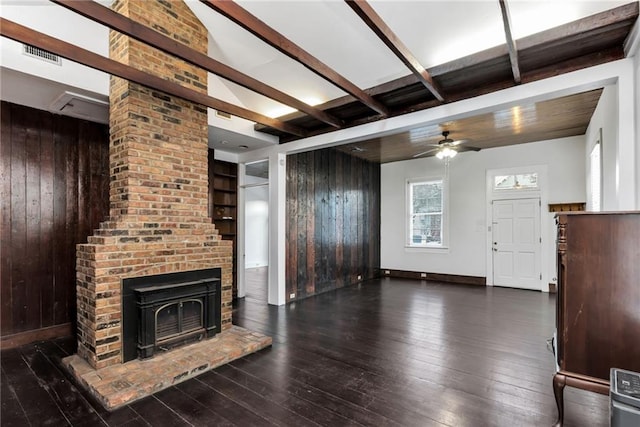 unfurnished living room featuring dark hardwood / wood-style floors, ceiling fan, and wood walls