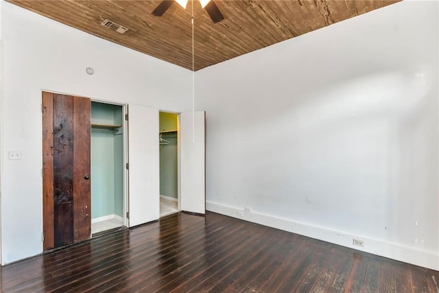 unfurnished bedroom featuring a high ceiling, ceiling fan, dark wood-type flooring, and wood ceiling