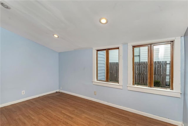 spare room featuring wood-type flooring