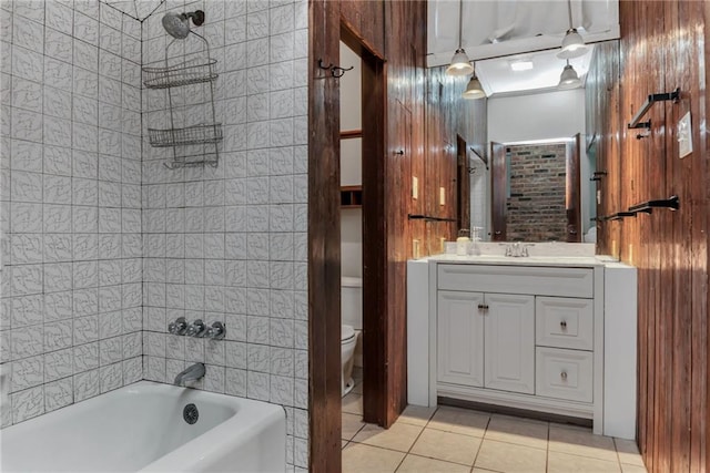 full bathroom with tiled shower / bath, vanity, toilet, and tile patterned flooring