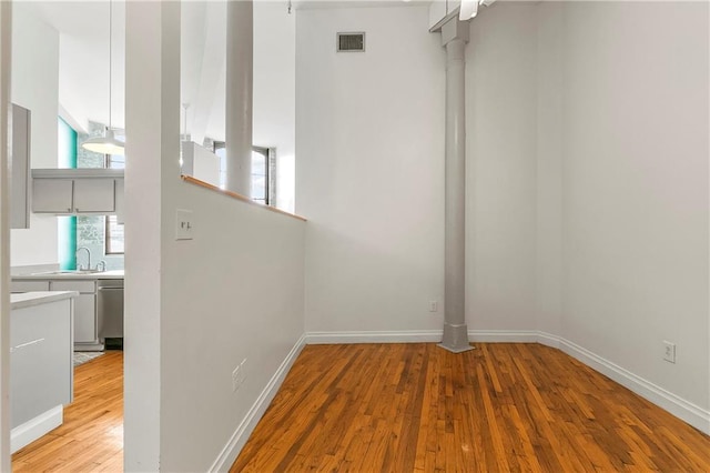 spare room featuring sink and light hardwood / wood-style floors