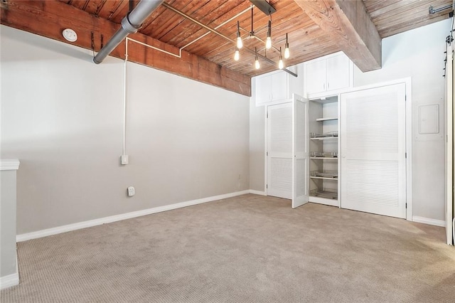 interior space featuring beamed ceiling, wood ceiling, carpet flooring, and a closet