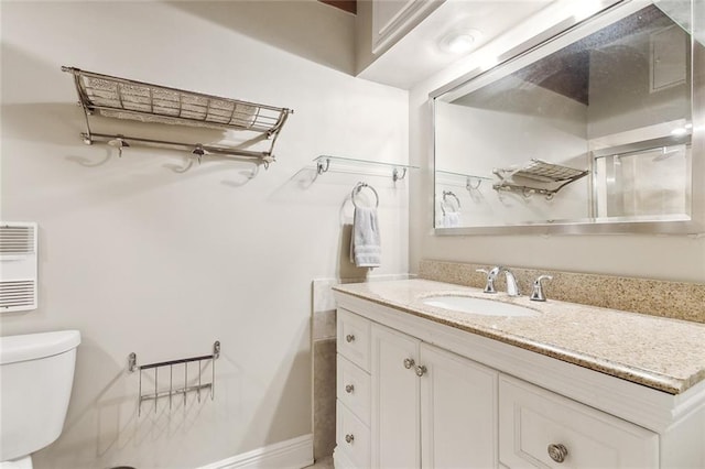 bathroom featuring vanity and toilet