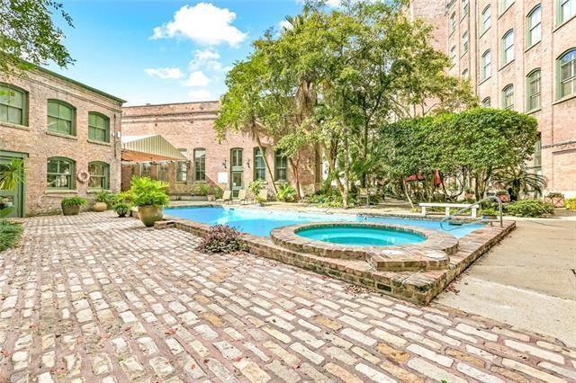 view of pool featuring a patio and a community hot tub