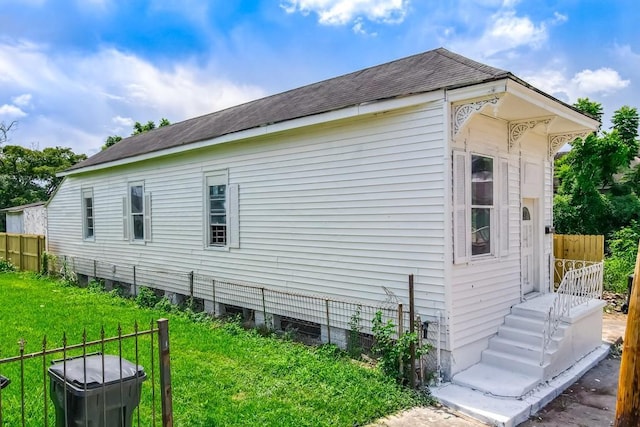 view of side of home featuring a lawn