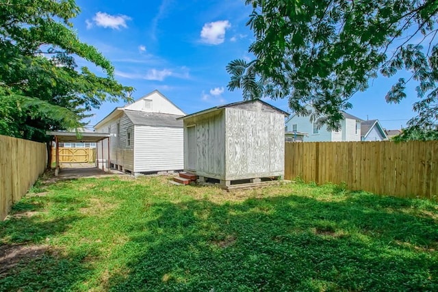 view of outdoor structure featuring a carport and a yard