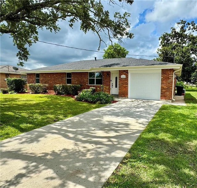 ranch-style home featuring brick siding, a front yard, concrete driveway, and an attached garage