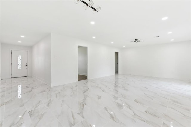 unfurnished room with recessed lighting