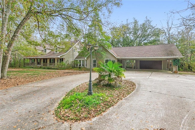 109 Lefleur Dr, Slidell, LA 70460 - view of front of home featuring curved driveway, an attached garage, an attached carport, and a porch