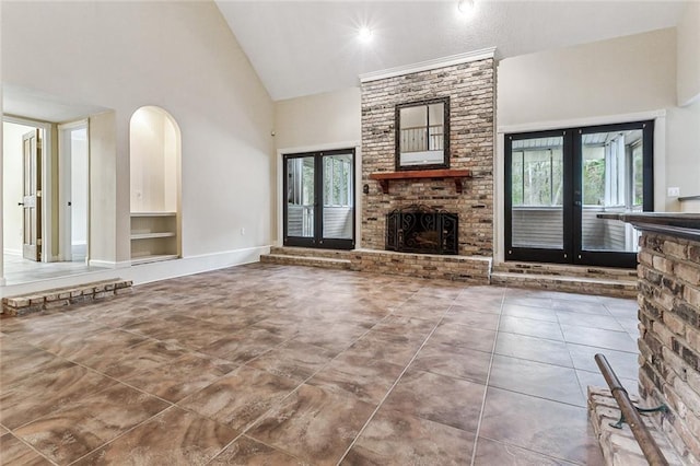 109 Lefleur Dr, Slidell, LA 70460 - unfurnished living room featuring high vaulted ceiling, a brick fireplace, french doors, plenty of natural light, and built in features