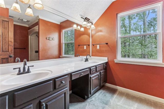 109 Lefleur Dr, Slidell, LA 70460 - bathroom with double vanity, lofted ceiling, and a textured ceiling