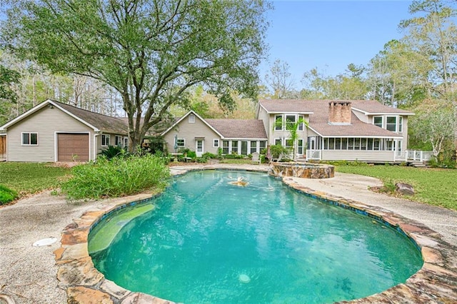 view of swimming pool featuring a sunroom and a lawn