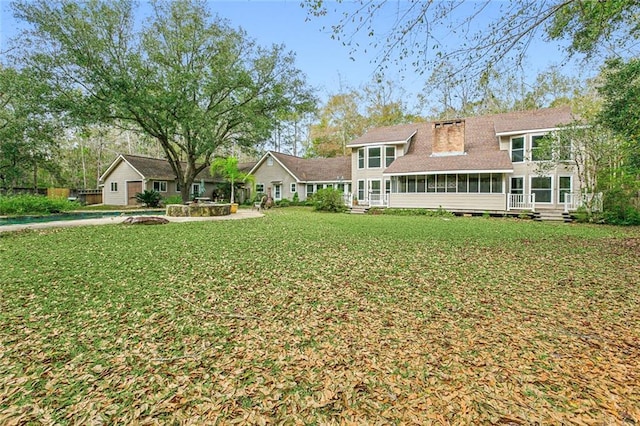 109 Lefleur Dr, Slidell, LA 70460 - back of house with a sunroom, a yard, and a pool