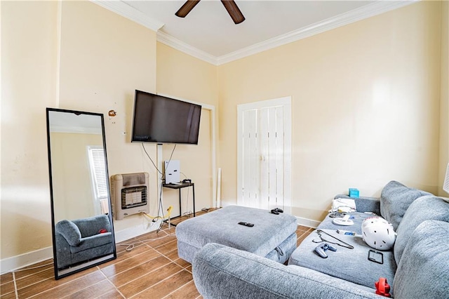 living room with crown molding, ceiling fan, and heating unit