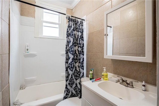 full bathroom with tile walls, vanity, toilet, crown molding, and shower / bathtub combination with curtain