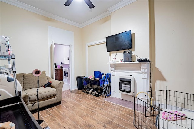 living room with crown molding, ceiling fan, and heating unit