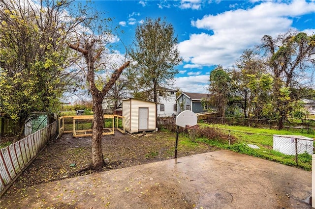 view of yard with a storage shed and a patio