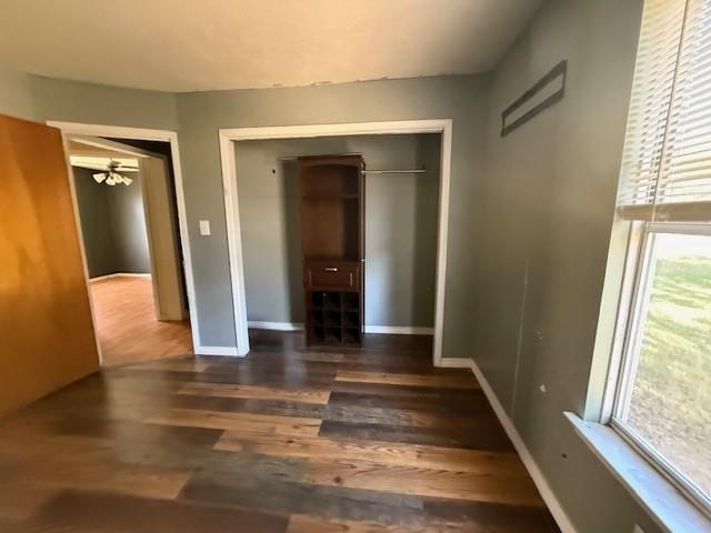 unfurnished bedroom featuring dark hardwood / wood-style flooring and a closet