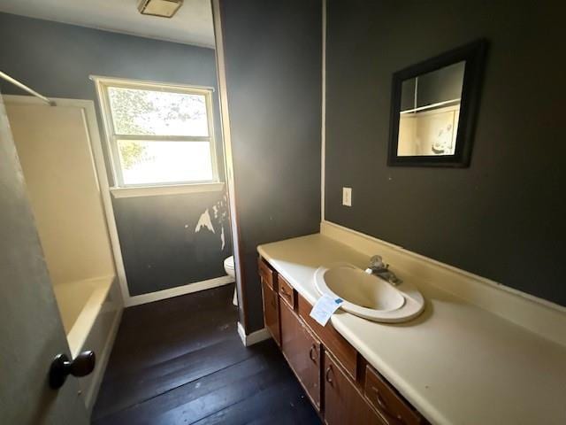 bathroom with vanity, hardwood / wood-style floors, and toilet