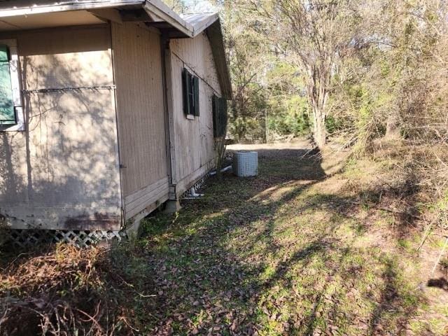 view of side of home with central air condition unit