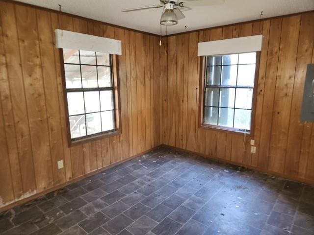 unfurnished room with wooden walls and a healthy amount of sunlight