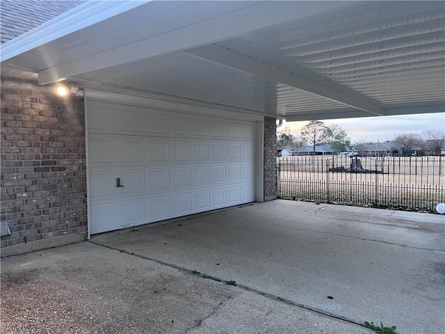 view of garage at dusk