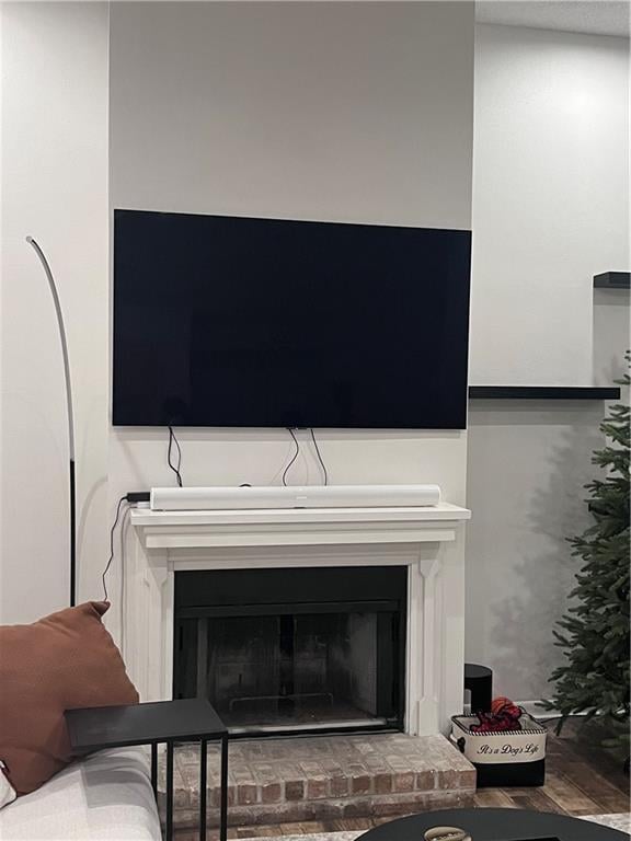 interior details featuring a brick fireplace