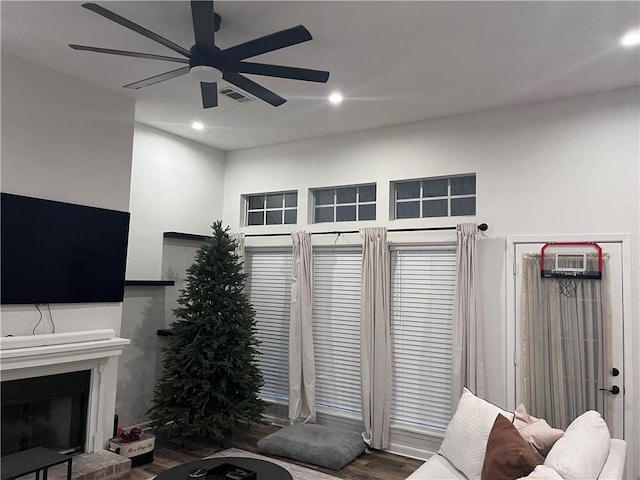 living room featuring hardwood / wood-style floors and ceiling fan